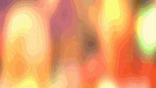 a blurred image of a person 's face with a yellow and orange background