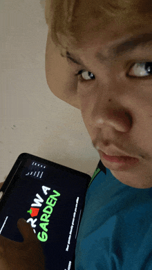 a man holding a tablet that says rawa garden
