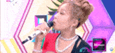 a woman singing into a microphone with the words comeback on the bottom right