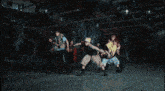 a group of people are dancing in a dark room and one of them is wearing a hat that says ' da ' on it