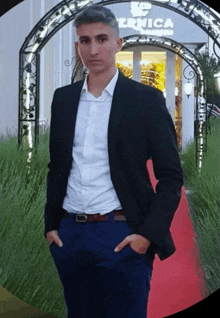 a man in a suit is standing in front of a building that says vernica
