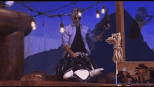 a man in a cowboy hat rides a bull