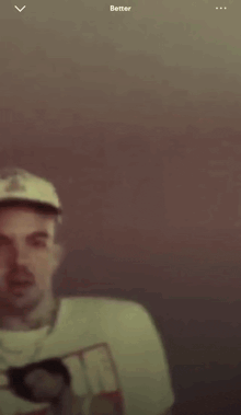 a blurry picture of a man wearing a t-shirt that says ' better '
