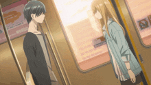 a man and a woman are standing next to each other on a subway train