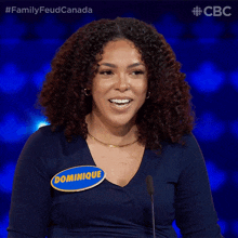 a woman with a name tag that says dominique is smiling