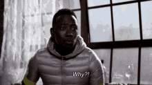 a man in a silver jacket says why