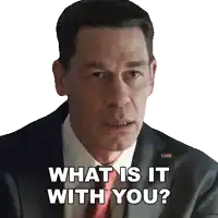 a man in a suit and tie asks " what is it with you "