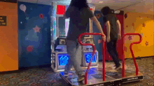 two people are dancing on a dance machine in a room with a sign that says " no open tea " on it