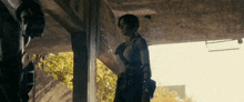 a woman in a tank top is standing in a building