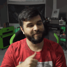 a man with a beard is wearing a red shirt that says ' the north face '