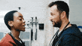 a doctor and a nurse are looking at each other in a hospital room .