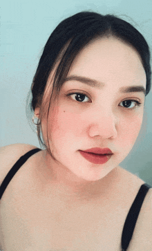 a close up of a woman 's face with a red lip