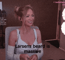 a woman sitting in a chair with the words larsens beard is massive on the bottom