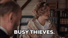 a woman talking to a man with the words busy thieves