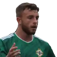 a man wearing a green adidas shirt looks to his left
