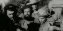 a black and white photo of a group of men with beards