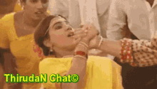 a woman in a yellow dress is being held by a man in a yellow shirt .