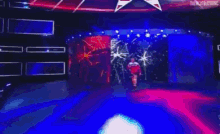 a wrestler is walking on a stage in front of a crowd .
