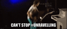 a man playing a guitar with the words can 't stop #unravelling