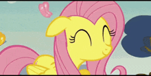 a cartoon of a yellow and pink pony with a pink tongue sticking out