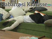 a person laying on a green couch with the words " habang si klarise " above them
