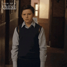 a young boy is standing in a hallway with the words son of a gift on the bottom