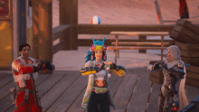 a woman in a colorful outfit is standing on a wooden deck