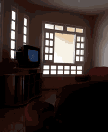 a living room with a red couch and a flat screen tv