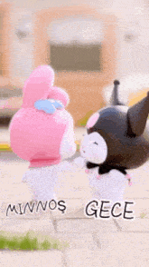 a couple of hello kitty dolls standing next to each other on a sidewalk .