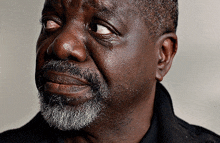 a close up of a man 's face with his eyes closed