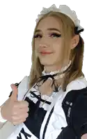 a person wearing a maid costume giving a thumbs up