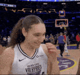 a female basketball player for the golden state valkyries smiles