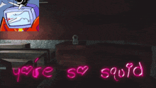 a neon sign that says " you 're so squid " is next to a stuffed animal