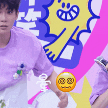 a man in a purple shirt is holding a microphone in front of a colorful background with a smiley face on it