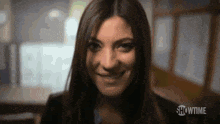a close up of a woman 's face smiling in a blurry photo .