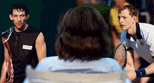 two men are playing tennis on a court and one of them has a name tag that says ' alonso ' on it