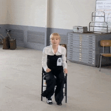 a woman sitting in a chair with a name tag that says ' abercrombie ' on it