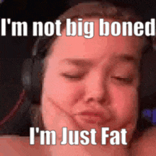 a woman wearing headphones is making a funny face and says `` i 'm just fat '' .