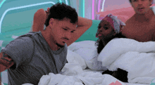 a man and a woman are laying in a bed