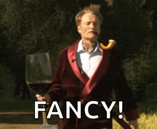 a man with a pipe in his mouth is holding a glass of wine and the word fancy is below him