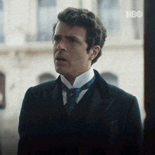 a man in a suit and tie with hbo written on the bottom
