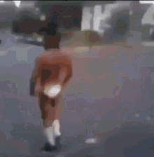 a man without a shirt is walking down the street .