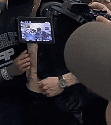 a man with a rolling stones tattoo on his stomach is being filmed