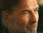 a close up of a man 's face with the words emilythegoat visible