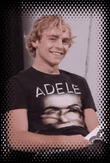 a man wearing a black t-shirt that says adele