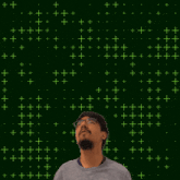 a man stands in front of a green background with the number 12 on it