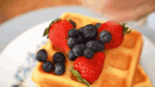 waffles syrup strawberries blueberries breakfast