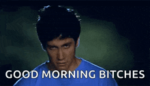a man in a blue shirt is making a funny face and saying `` good morning bitches '' .