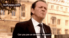 a man in a suit and tie is asking if he can pee on demand .