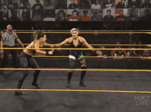two women wrestling in a ring with the words nxt live on the screen